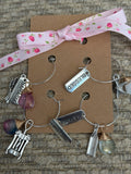 Handmade glass bottle charms featured in a bracelet with unique decorative elements and a pretty ribbon.